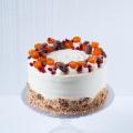 Carrot cake decorated with candied kumquats and sugared pecans